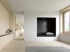 Plaster walls mixed with gray marble powder dominate the interior of the bottom floor, complementing its spruce wood carpentry. Photo 6 of Sven Matt's Simple Gabled Home modern home