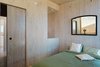 Modern home with Bedroom, Bed, and Wall Lighting. The bedroom is outfitted with only the basics. Photo 6 of Sky House