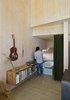 The floating bookshelf is composed from wood found on the property. Photo 8 of Sky House modern home