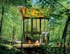 Modern home with Exterior, Cabin Building Type, and Shed RoofLine. A cantilevered cabin designed by R D Gentzler blends into the forest, even as it hovers above a 20-foot drop-off. Its south face is almost entirely glass, but a roof canopy limits solar gain. Photo 3 of Gentzler's Cantilevered Cabin
