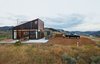 Modern home with Back Yard, Grass, Shrubs, Exterior, House, Metal Roof Material, and Metal Siding Material. A narrow building next to the main structure houses storage and an outdoor kitchen. Photo 2 of Sky House