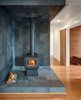 Vermont slate covers the area around the True North wood stove. Photo 4 of Gordon Cabin modern home