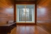 The room is clad entirely in bamboo and frames a view of the surrounding deciduous forest. Photo 3 of Gordon Cabin modern home