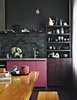 Modern home with Kitchen, Colorful Cabinet, Range Hood, Pendant Lighting, and Wood Cabinet. He created the star as a prop for a photo shoot. The kitchen cabinets benefit from a pop of rosy color, a custom hue. Fehrentz designed the steel-and-wood storage unit. Photo of The Dwell Guide to Kitchen Design