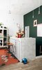 Modern home with Dining Room, Bar, Stools, Pendant Lighting, and Light Hardwood Floor. Jean-Christophe Aumas’ multihued Paris apartment houses both the highly sought artistic director and the stunning assemblage of furniture he’s brought back from his travels. Photo by Christian Schaulin. Photo of The Dwell Guide to Kitchen Design