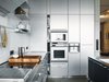 Modern home with Kitchen, Refrigerator, Metal Cabinet, Metal Counter, and Wall Oven. The stainless steel Bulthaup kitchen “cost as much as a small house,” said Spiekermann, though he did get a discount: Bulthaup is one of his clients. Photo of The Dwell Guide to Kitchen Design