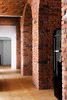 Modern home with Kitchen and Refrigerator. Loft Szczecin designed several pieces of original plywood furniture for the kitchen. The jet-black refrigerator is from Smeg. Photo of These Days This Warehouse-Turned-Loft in Poland Stores a Stockpile of Cool, Vintage Furniture