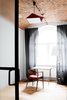 Modern home with Office, Chair, and Desk. In most of the loft, the original wood flooring and the herringbone pattern of the vaulted brick ceiling have been carefully preserved. Photo of These Days This Warehouse-Turned-Loft in Poland Stores a Stockpile of Cool, Vintage Furniture