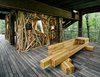 A bench offers a place to rest and take in the surrounding tree canopy. Creating opportunities for contemplation is another key element of the structure's design. Photo 7 of Sustainability Treehouse modern home