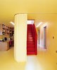 Modern home with Office and Painted Wood Floor. When residents want privacy (from the outside world or from other family members), sliding curtains, like this one dividing the office from the staircase, create temporary walls between rooms. "When you close the curtains, you can't see anything," says Wibowo. "It's more like Asian culture, where you don't want to show everything all at once. We want to be in control of what guests see." Photo of 17 Stellar Uses of Color in Home Offices