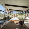 The interior of the Menrad residence, with a raised ceiling and glass walls. "The house felt like the ultimate expression of what postwar residential architecture in California was all about," resident Chris Menrad writes in the book. Photo of Midcentury Lovers: You Can Thank This Architect for Transforming Palm Springs Into a Modernist Hotbed modern home