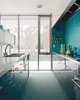 Modern home with Kitchen and Mosaic Tile Backsplashe. A mosaic tile wall softens the laboratory-like effect of the glossy kitchen cabinets. Photo of Tips and Tricks for Bringing Color Into the Kitchen