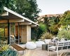 Modern home with Outdoor, Large Patio, Porch, Deck, Concrete Patio, Porch, Deck, Back Yard, Grass, Shrubs, Trees, and Gardens. The beanbag chairs and outdoor sofa and chairs are from West Elm and the Case Study Museum Bench is from Modernica. Photo of Modern Master: Joseph Eichler