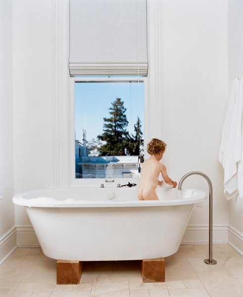 Jonathan Nelson’s one wish for the master bathroom was for views from the Zuma tub. He got that and then some, and now three-year-old Jonas (pictured) and his older brother refuse to bathe anywhere else. The stand-alone faucet is by Lefroy Brooks from the XO collection.