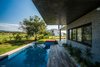 Surrounding a volcano in Colima, México, Di Frenna Arquitectos designed a home that plays off the natural setting with a variety of textures from the facade to the vegetation. Photo of A Home Rocks Out with Natural Stone, Concrete, and a Volcano modern home