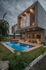 The lower level has a natural stone facade while polished concrete defines the upper level. Windows made with ClimaGuard glass provide sweeping views of the scenic landscape. Photo 2 of A Home Rocks Out with Natural Stone, Concrete, and a Volcano modern home