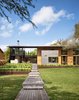 Modern home with Exterior, House Building Type, Flat RoofLine, and Wood Siding Material. “Consistent with the lakefront cabin charm, the owners liked the idea of accessing much of the house from outdoor porches and walkways,” says architect Ted Flato. Supplies from Dynamic Architectural Windows and Doors bring light in to the home’s covered spaces. Photo of Hog Pen Creek