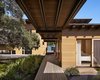 Modern home with Outdoor, Wood Patio, Porch, Deck, Walkways, and Back Yard. “The unique site-plan includes the main house, a two-story dog run, and a guest cabin,” Flato says. “All are seamlessly stitched together by a grand boardwalk, making an arrival by boat or by car an equally engaging experience.” Vertical grain Western red cedar acts as the exterior siding. Photo 2 of Hog Pen Creek