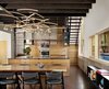 Modern home with Dining Room, Table, Chair, and Pendant Lighting. “We wanted to bring the outside in with the warmth of the materials,” Flato says. “A custom dining table and shelving were designed and built from a pecan tree that had fallen on the site.” Vertical grain Western red cedar, the same material used for the exterior siding, was also used to create custom kitchen cabinets. Photo 3 of Hog Pen Creek