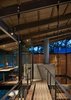 Modern home with Office and Chair. We love this sleek home office design layout, where steel details contrast mesquite flooring throughout the home, including at the pathway to the "crow’s nest" office. It's also a great option if you're looking for home office ideas for small spaces. Photo 4 of Hog Pen Creek