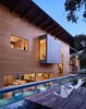 Modern home with Large Pools, Tubs, Shower, Wood Patio, Porch, Deck, Small Patio, Porch, Deck, Back Yard, Exterior, House Building Type, and Wood Siding Material. “Exposing the craft and detail of the materials was a key part of the design,” Flato notes. The texture of the house, he says, can be observed in the concrete retaining wall for the lap pool. Photo 7 of Hog Pen Creek