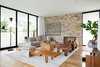 The family room boasts a Monza Triennale Floor Lamp by Gino Sarfatti and a Long John Bench by Edward Wormley, both from the 1950s, as well as a pair of ‘60s rosewood and leather ‘925’ lounge chairs by Arfa and Tobia Scarpa. Pieces by Ludwig Mies van der Rohe and Alvar Aalto also fill the space. Photo 5 of Preston Hollow modern home