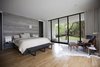 In the master bedroom, the textural appeal of the reclaimed wood wall, bedding, and rug contrasts with the black leather of the African-inspired ‘Bwana’ Chair by Finn Juhl, which sits beside a ‘TAB’ reading lamp by Barber Osgerby. “We believe a quality project is defined by the sum of all its parts versus any individual feature or design move,” Field says. Photo 6 of Preston Hollow modern home