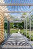 Tack Architects designed the house to frame views of the surrounding landscape. The trellis offers shading and controls the amount of daylight that shines inside (and creates a dramatic passage along the house's perimeter). Photo 4 of Omaha Art-Inspired House modern home