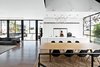 Modern home with Dining Room, Table, Dark Hardwood Floor, Chair, Recessed Lighting, Pendant Lighting, and Rug Floor. The fourth-floor kitchen features appliances by Miele, and Heracleum II pendants by Bertjan Pot for Moooi hang over both the kitchen island and the dining table. Photo of Eames Molded Chairs