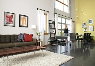 The living area features a Petrie sofa from Crate & Barrel and a Wassily chair by Marcel Breuer from Knoll. A vintage walnut coffee table by Lane Furniture sits atop a rug that the couple purchased at Weisshouse, a Pittsburgh home-furnishings store.