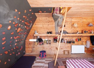Setsumasa and Mami Kobayashi’s weekend retreat, two and a half hours northwest of Tokyo, includes a rooftop tent that can be accessed from the interior via a wooden ladder or—for the more athletic—via a series of wall-mounted climbing holds, made by Vock and carved from persimmon-tinted hardwood. Photo by Dean Kaufman.