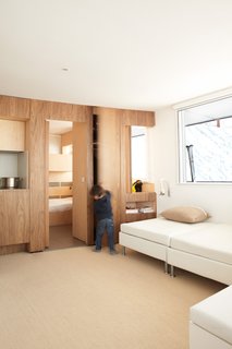 Built-ins abound in this renovation of a 1970s lodge perched high in the French Alps. H2O Architectes devised a plan to increase livable space while leaving the structure intact. Panels slide open to connect the spaces, or closed for privacy.