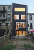 The rear facade, like the top-floor addition, is faced in rectangular panels of black rainscreen Richlite over exterior mineral wool insulation. Photo of Super-Insulated Houses That Stand Up to Winter's Chill modern home