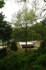 Modern home with Exterior, House Building Type, Cabin Building Type, and Green Roof Material. Visitors enter through a narrow staircase, visible here as a slit to the right of the courtyard. Photo of Architect Spotlight: Byoung-soo Cho