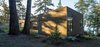 Modern home with Exterior and Wood Siding Material. “The liberal use of wood roots the structure in the landscape and provides the owners with an experience strongly connected with location,” Herrin says. The exterior’s Western red cedar shingle siding has a semi-transparent stain, half Fieldstone and half Burnt Hickory from Cabot. Photo 7 of San Juan Islands Residence