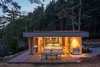 Modern home with Wood Patio, Porch, Deck, Large Patio, Porch, Deck, Exterior, Back Yard, House Building Type, Green Roof Material, Wood Siding Material, Cabin Building Type, and Flat RoofLine. One of the main goals of the construction was to do as little harm as possible to the existing environment, which includes waterways that salmon depend upon. Herrin and his team created a garden roof that covers the full extent of the home to meet this objective. “This helps control storm water runoff and also replaces lost insect habitat—insects being a critical food source for juvenile salmon,” he says. Photo 8 of San Juan Islands Residence