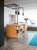 Modern home with Kitchen, Concrete Floor, Rug Floor, and Pendant Lighting. Polished statuario marble covers both the island's countertop and the backsplash in the custom kitchen cabinet block. PSLAB designed the light fixtures. Photo of This Berlin Apartment Manages to Be Totally Adorable in Only 900 Square Feet