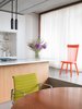 Modern home with Dining Room, Table, and Chair. A polished concrete floor was selected for its durability. Using a design move inspired by Japanese architecture, Bruzkus introduced a change in height to help separate the sleeping area from the living area. Photo of This Berlin Apartment Manages to Be Totally Adorable in Only 900 Square Feet