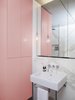 Modern home with Bath Room, Pendant Lighting, Marble Wall, Wall Mount Sink, Corner Shower, and Pedestal Sink. Statuario marble appears again in the bathroom, where it contrasts pink cabinets that create ample room for storage. Photo of This Berlin Apartment Manages to Be Totally Adorable in Only 900 Square Feet