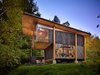 Modern home with Exterior, Cabin Building Type, Wood Siding Material, Shed RoofLine, and Glass Siding Material. Anna Hoover, founder of the non-profit First Light Alaska, sought a "thought refuge, a room with a view to sit and contemplate future projects and reflect on recent travels and interactions, plenty of ‘headspace’—tall ceilings—and the ability to host other artists for studio time," she says. A longtime resident of the Pacific Northwest, Hoover was familiar with the work of Olson Kundig and contacted the Seattle-based firm to design her abode. Photo of An Eco-Friendly Compact Cabin in Washington