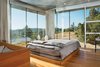 The aircraft cables that crisscross the windows provide structural support for the house—and an unexpected benefit. “They’re handy for drying laundry!” says Ohm. The custom silk drapes help control sun exposure, as does the deep roof overhang. “It’s only in the winter that the sun starts to angle in,” says Ohm. Photo 3 of Mayacamas Residence modern home