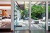 The yard is paved with Texas limestone and bluestone and features a Mayan-inspired koi pond. Photo 4 of Warwick Evans House modern home
