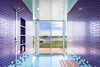 Modern home with Bath Room, Ceramic Tile Wall, Ceramic Tile Floor, Ceiling Lighting, and Open Shower. Consider this lively bathroom that sits within a recently completed waterfront home in Bridgehampton, New York. Situated on two-and-a-half acres of land with 360-degree views of the nearby bay and ocean, it's covered with brightly colored floor-to-ceiling tiles that reflect the shades of the neighboring water. One step through the sliding glass doors and you’ll find yourself on an open terrace. Photo of 50+ Modern Tile Ideas for Walls, Floors and Ceilings
