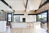 The kitchen, which also features an oven by Miele, is separated from an outdoor deck by an A14 sliding door by Centor. Photo 4 of Water Factory modern home