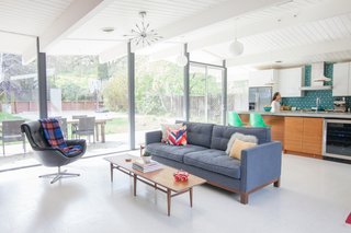 Originally designed by the architectural dream team of A. Quincy Jones and Frederick Emmons, this Eichler sports a new kitchen. One highlight is the island, which the design team crafted in the owners' own backyard. It's outfitted with bespoke walnut cabinetry by Semihandmade for IKEA. 