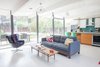 Modern home with Living Room, Sofa, Chair, and Coffee Tables. Built by Joseph Eichler, the home was designed by A. Quincy Jones and Frederick Emmons. While bringing the home back to its former glory, the family with two children also made some modern updates. Karen Nepacena and John Shum upgraded the kitchen with an island, which was built in the couple’s backyard, with custom Walnut cabinetry by Semihandmade Doors from IKEA around it. Photo of DIY All-Stars! A Family Rolls Up Their Sleeves and Restores an Eichler