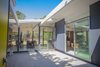 Modern home with Exterior and House Building Type. Materials original to classic Eichler homes such as interior wood paneling, aluminum sliding doors, glass walls, and VCT flooring were restored. Photo of DIY All-Stars! A Family Rolls Up Their Sleeves and Restores an Eichler