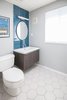 Modern home with Bath Room, Wall Mount Sink, and Two Piece Toilet. The renovated bathroom features tiles from Heath Ceramics. Photo of DIY All-Stars! A Family Rolls Up Their Sleeves and Restores an Eichler
