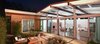 A 40-foot wall of sliding doors exposes the great room to the courtyard. The master bedroom also opens up to the outdoor space. The yard uses pervious paving and drought-tolerant plant species to reduce runoff and save water. Photo of If Eichler Designed a House Today, This Is What It Might Look Like modern home