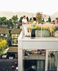 Each of the residences has outdoor space attached to it; the family’s unit has a roof deck. In
lieu of a green roof is a galvanized tub filled with grasses—a collaboration between the architects
and landscape architecture firm space2place. Photo of Modern Spaces in the Pacific Northwest modern home